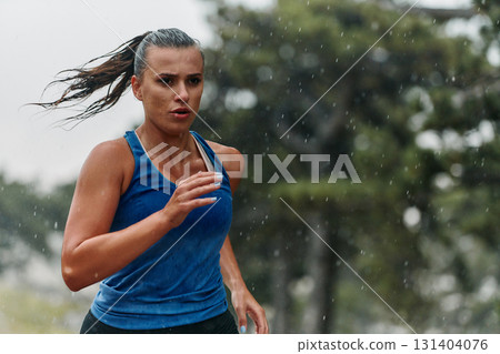 Unstoppable: A Determined Athlete Trains Through the Rain in Pursuit of Marathon Glory 131404076