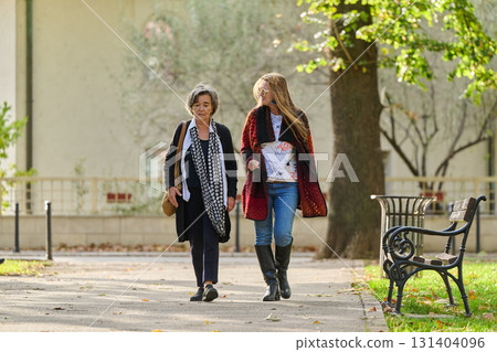 Autumn Walk: A Mother and Daughter Share Love and Support in Natures Embrace. 131404096