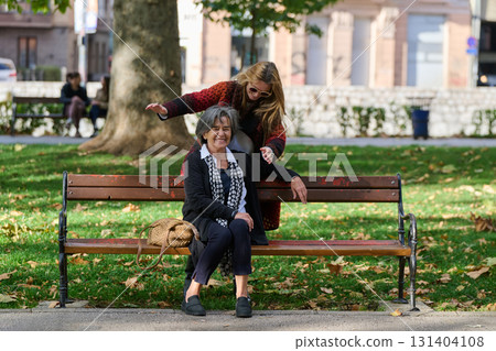 Embracing Generations: A Daughter's Love and Support for Her Senior Mother on a Sunny Day in the Park 131404108