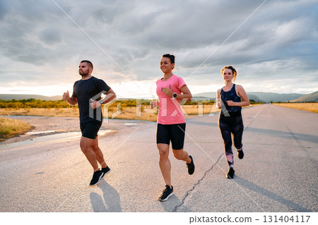 Athlete Leading Group Run at Sunset Amidst Stunning Nature 131404117