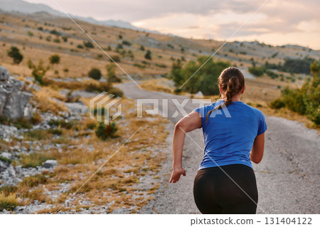 Empowered Runner Embracing Nature's Beauty on a Serene Morning Trail. Empowered Runner Embracing Nature's Beauty on a Serene Morning Trail. 131404122