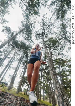 Adventurous Woman Overcoming Forest Obstacles with Determination and Agility. 131404123