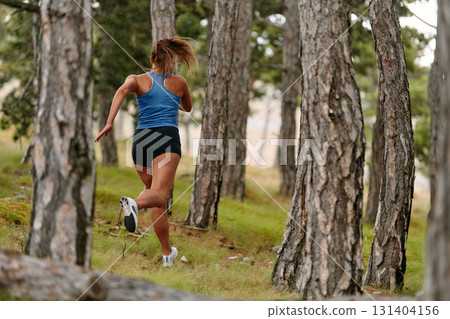 Fearless Woman Conquering Wooden Obstacles in the Dangerous Forest Terrain. 131404156