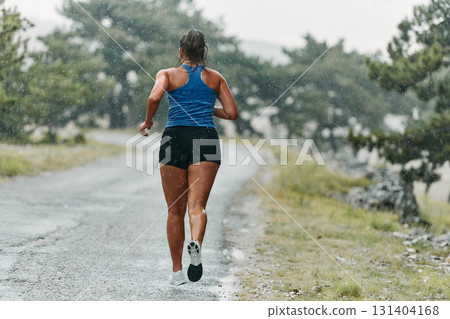 Unstoppable: A Determined Athlete Trains Through the Rain in Pursuit of Marathon Glory 131404168