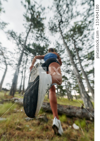 Adventurous Woman Overcoming Forest Obstacles with Determination and Agility. 131404180