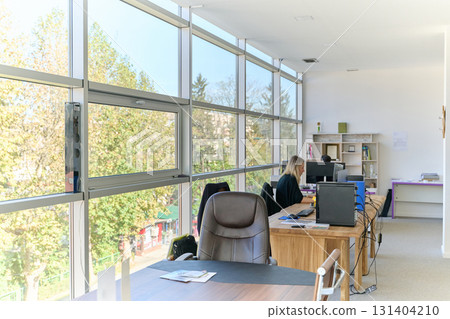 Modern Office Interior with Wooden Furniture, Conference Table, and Computers Modern Office Interior with Wooden Furniture, Conference Table, and Computers 131404210