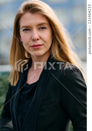 Portrait of a Stylish Business Blonde Posing on Terrace in Urban Cityscape. Portrait of a Stylish Business Blonde Posing on Terrace in Urban Cityscape. 131404233