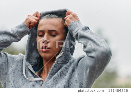 Woman Resting in the Rain After Intense Run 131404236
