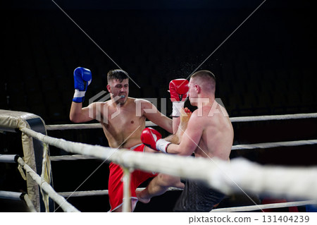 Fierce boxing match showcases athletes' power and skill. 131404239
