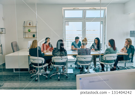 Diverse Business Team Discussing Projects in a Modern Glass Office. Diverse Business Team Discussing Projects in a Modern Glass Office. 131404242