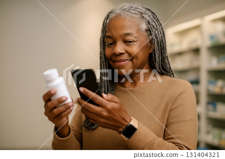 AI generated senior Black woman scanning a medication bottle with her smartphone in a pharmacy. She is wearing a stylish smartwatch and surrounded by health products with a modern digital touch. 131404321