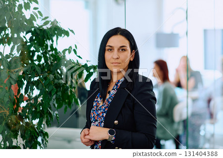 Portrait of a Confident Businesswoman with Crossed Arms in Her Office Environment. 131404388