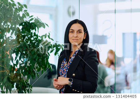 Portrait of a Confident Businesswoman with Crossed Arms in Her Office Environment. 131404405