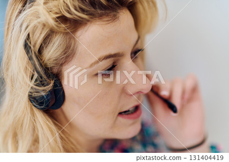 Friendly Call Center Agent Answering Incoming Calls with Headset Providing Remote Customer Service. Friendly Call Center Agent Answering Incoming Calls with Headset Providing Remote Customer Service. 131404419