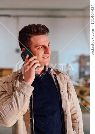 Engineer Using Smartphone in Warehouse of Wood Furniture Production and Processing Company Engineer Using Smartphone in Warehouse of Wood Furniture Production and Processing Company 131404424