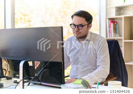 Company Director in a Modern Office, Focused on Work at Computer Company Director in a Modern Office, Focused on Work at Computer 131404426