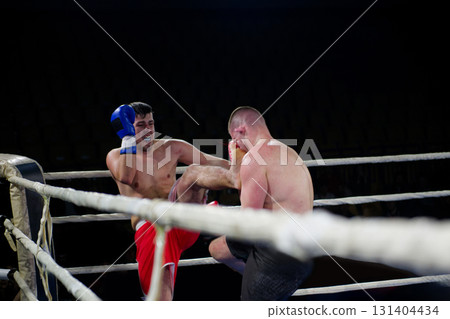 Fierce boxing match showcases athletes' power and skill. 131404434