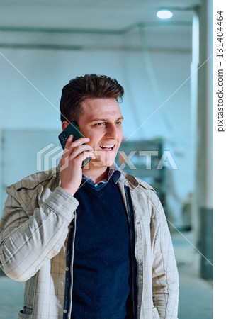 Engineer Using Smartphone in Warehouse of Wood Furniture Production and Processing Company 131404464