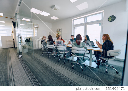 Diverse Business Team Discussing Projects in a Modern Glass Office. 131404471