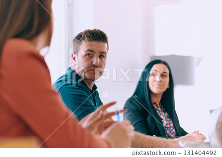 Diverse Business Team Discussing Projects in a Modern Glass Office. 131404492