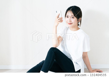 A woman using a smartphone 131404535
