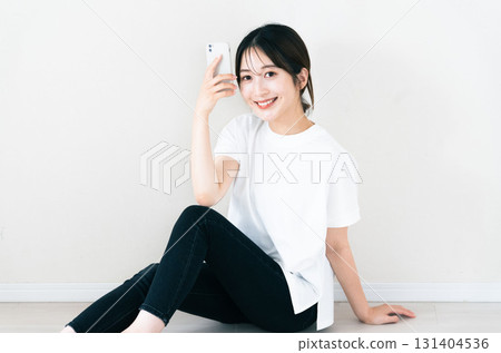 A woman using a smartphone 131404536