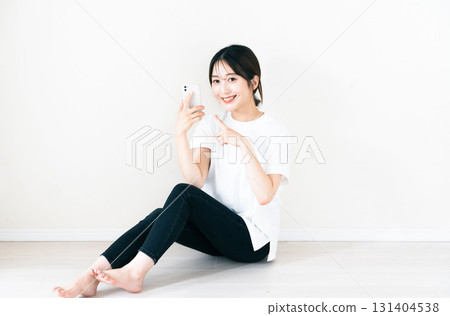 A woman using a smartphone 131404538
