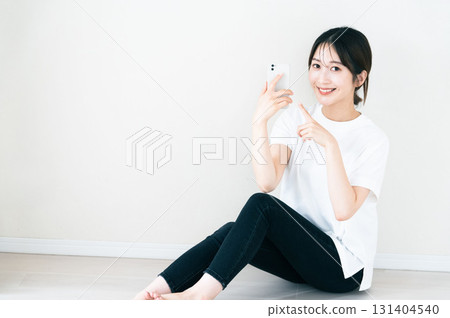 A woman using a smartphone 131404540