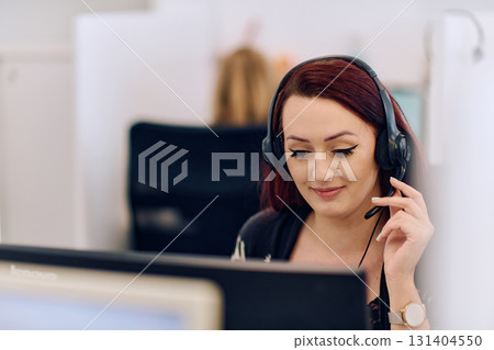 Friendly Call Center Agent Answering Incoming Calls with Headset Providing Remote Customer Service. Friendly Call Center Agent Answering Incoming Calls with Headset Providing Remote Customer Service. 131404550