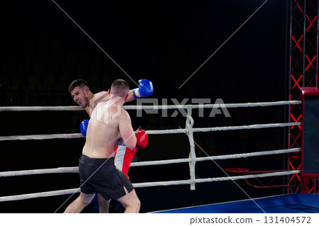 Fierce boxing match showcases athletes' power and skill. 131404572