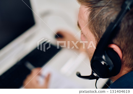 Close Up Portrait of a Customer Support Representative in a Call Center Environment. 131404619