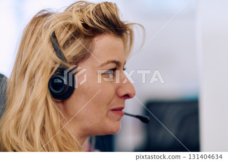 Friendly Call Center Agent Answering Incoming Calls with Headset Providing Remote Customer Service. Friendly Call Center Agent Answering Incoming Calls with Headset Providing Remote Customer Service. 131404634