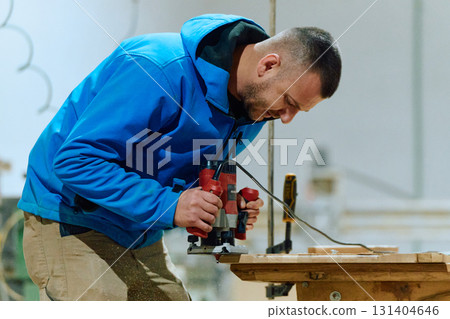 Close Up of Worker Carefully Cutting and Planing Wooden Pieces for Furniture in Wood Industry 131404646
