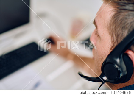 Close Up Portrait of a Customer Support Representative in a Call Center Environment. 131404656