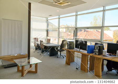 Modern Office Interior with Wooden Furniture, Conference Table, and Computers 131404662