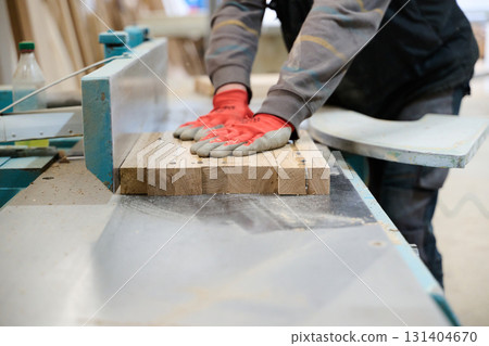 Close Up of Worker Carefully Cutting and Planing Wooden Pieces for Furniture in Wood Industry Close Up of Worker Carefully Cutting and Planing Wooden Pieces for Furniture in Wood Industry 131404670