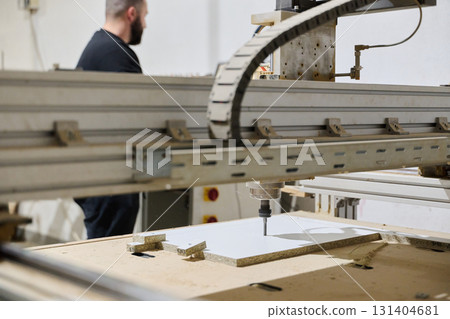 Close-Up of CNC Machine Precisely Cutting and Processing Wooden Boards 131404681
