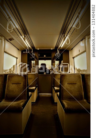 Interior of Public Transit Car With Symmetrical Seating and Solitary Passenger 131404882