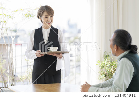 Female cafe staff and senior man Female cafe staff and senior man 131404911