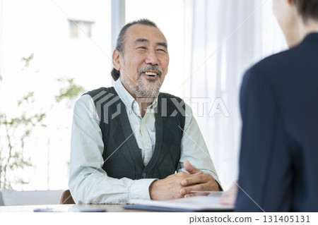Senior man talking face to face with businesswoman 131405131