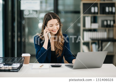 Confident Asian woman with a smile standing holding notepad and tablet Confident Asian woman with a smile standing holding notepad and tablet 131406028