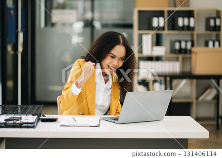 Business woman Talking on the phone and using a laptop at office 131406114