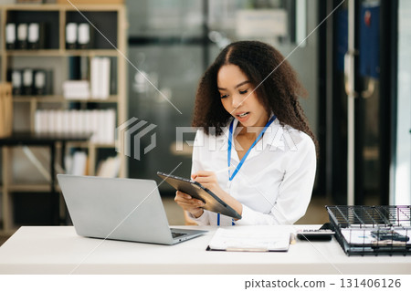 Confident business expert attractive smiling young woman holding digital tablet 131406126