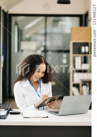 Confident business expert attractive smiling young woman holding digital tablet 131406127