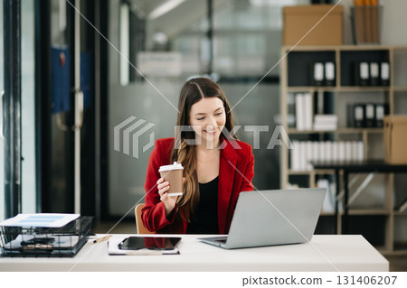 Confident Asian woman with a smile standing holding notepad and tablet 131406207