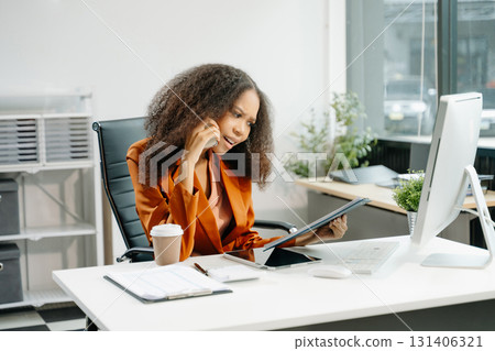 Confident business expert attractive smiling young woman holding digital tablet on desk in creative office. Confident business expert attractive smiling young woman holding digital tablet on desk in creative office. 131406321