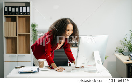 Confident business expert attractive smiling young woman holding digital tablet  on desk in creative office. 131406329