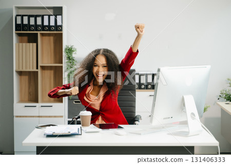 Confident business expert attractive smiling young woman holding digital tablet  on desk in creative office. 131406333
