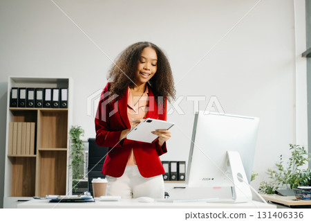 Confident business expert attractive smiling young woman holding digital tablet on desk in creative office. Confident business expert attractive smiling young woman holding digital tablet on desk in creative office. 131406336
