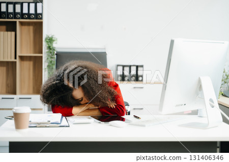 Overworked young Asian businesswoman office worker suffering from neck pain after had a long day office syndrome concept 131406346